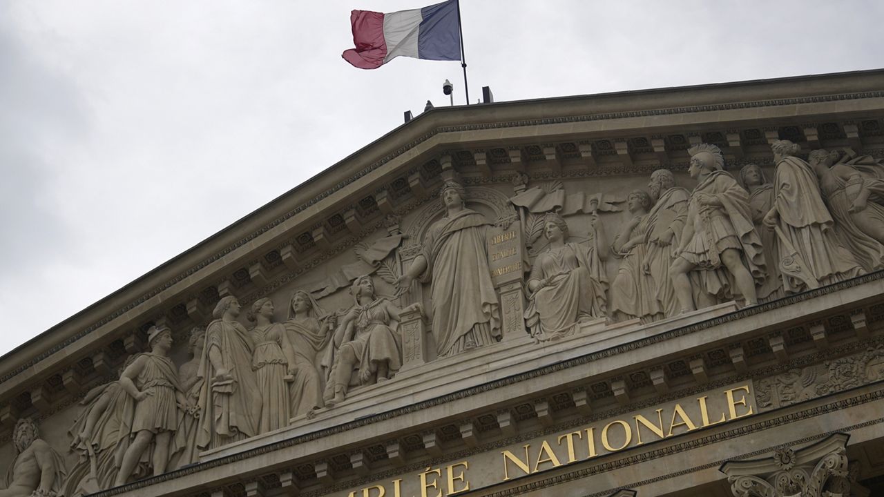 The French flag flies atop the French National Assembly Wednesday, July 3, 2024 in Paris. (AP Photo/Thibault Camus)