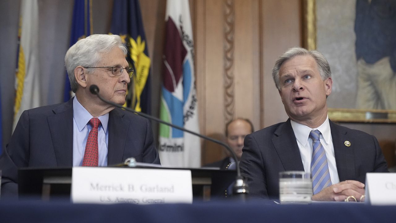 FBI Director Christopher Wray, right, speaks during a meeting of the Justice Department's Election Threats Task Force at the Department of Justice, Wednesday, Sept. 4, 2024, in Washington, as Attorney General Merrick Garland, left, looks on. (AP Photo/Mark Schiefelbein)