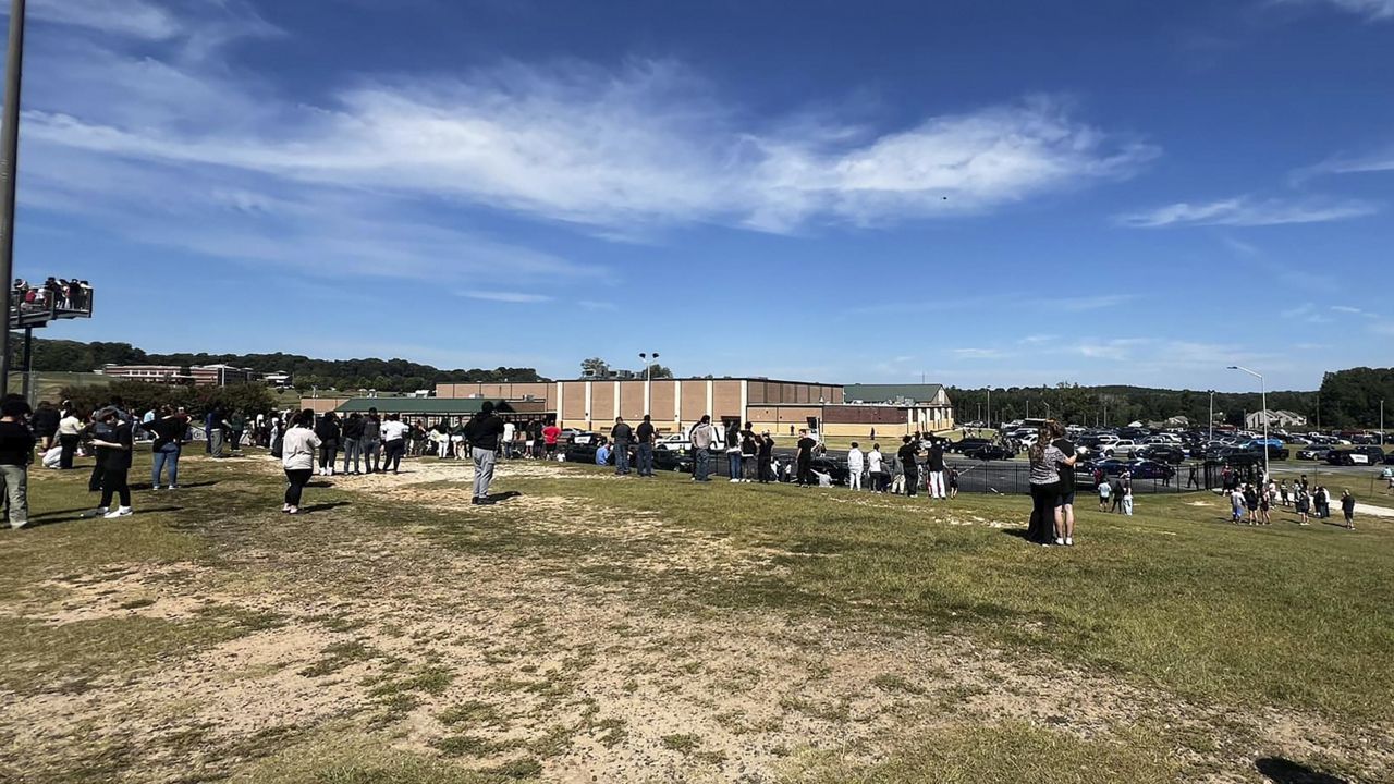 Students are evacuated to the football stadium after the school campus was placed on lockdown at Apalachee High School in Winder, Ga., on Wednesday, Sept. 4, 2024. (Erin Clark via AP)