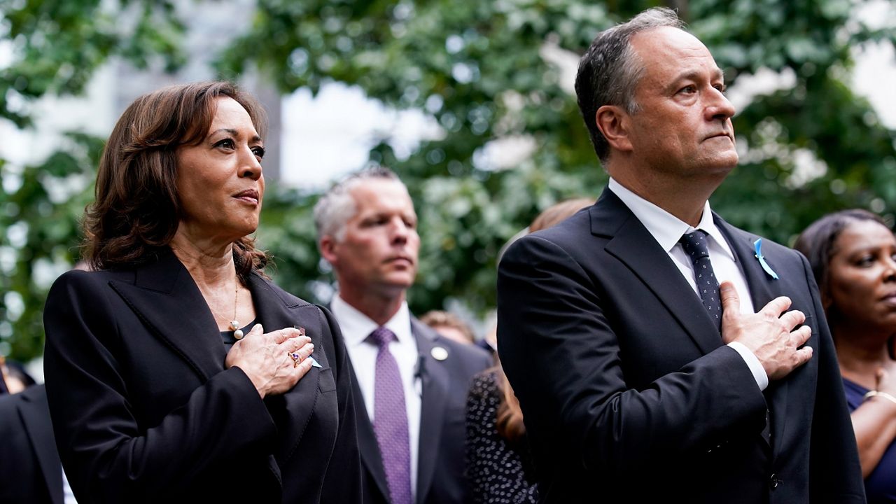 Vice President Kamala Harris and her husband Doug Emhoff stand for the national anthem at the ceremony to commemorate the 21st anniversary of the Sept. 11 terrorist attacks, Sunday, Sept. 11, 2022, at the National September 11 Memorial & Museum in New York. (AP Photo/Julia Nikhinson)