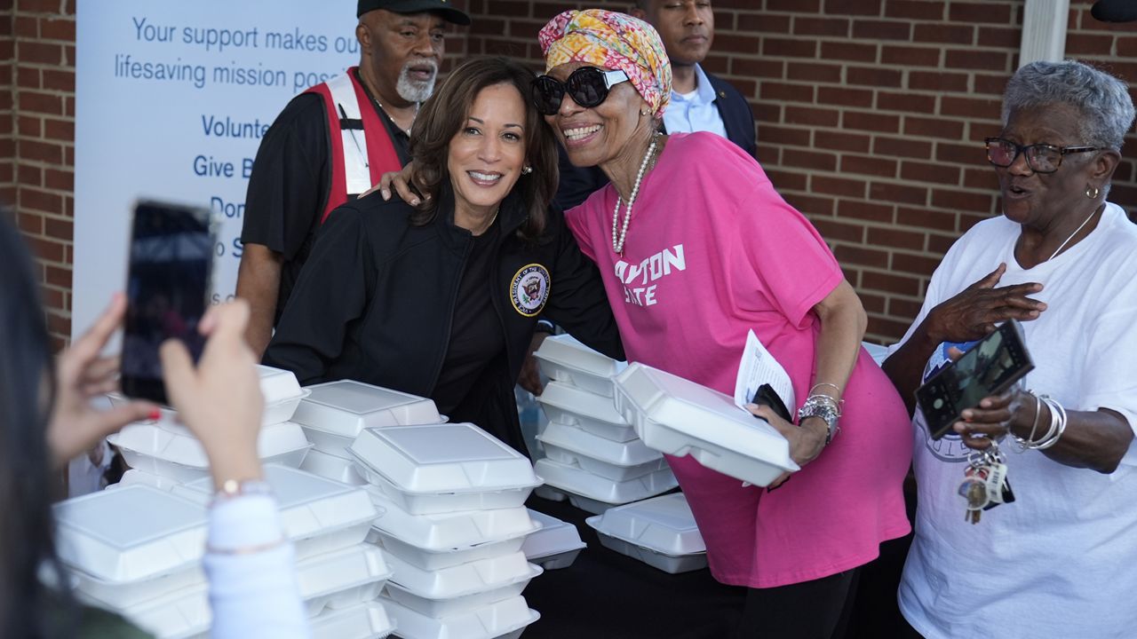 Democratic presidential nominee Vice President Kamala Harris poses for a photo as she helps distribute food with the American Red Cross at the Henry Brigham Community Center in Augusta, Ga., Wednesday, Oct. 2, 2024. (AP Photo/Carolyn Kaster)