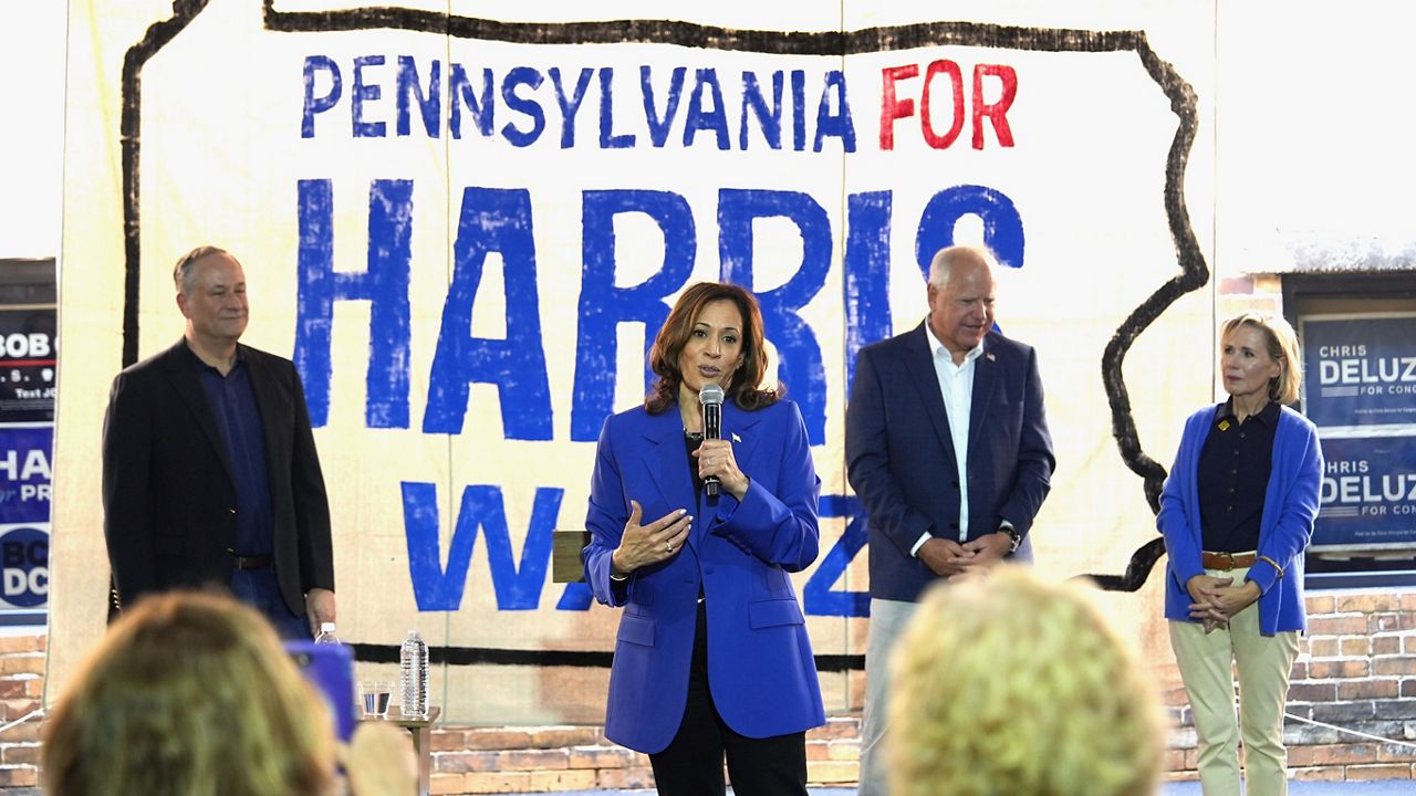 Democratic presidential nominee Vice President Kamala Harris claps alongside second gentleman Doug Emhoff as they greet supporters at Pittsburgh International Airport, Sunday, Aug. 18, 2024, in Pittsburgh. (AP Photo/Julia Nikhinson)