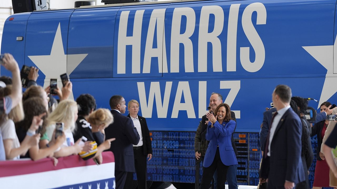 Democratic presidential nominee Vice President Kamala Harris claps alongside second gentleman Doug Emhoff as they greet supporters at Pittsburgh International Airport, Sunday, Aug. 18, 2024, in Pittsburgh. (AP Photo/Julia Nikhinson)