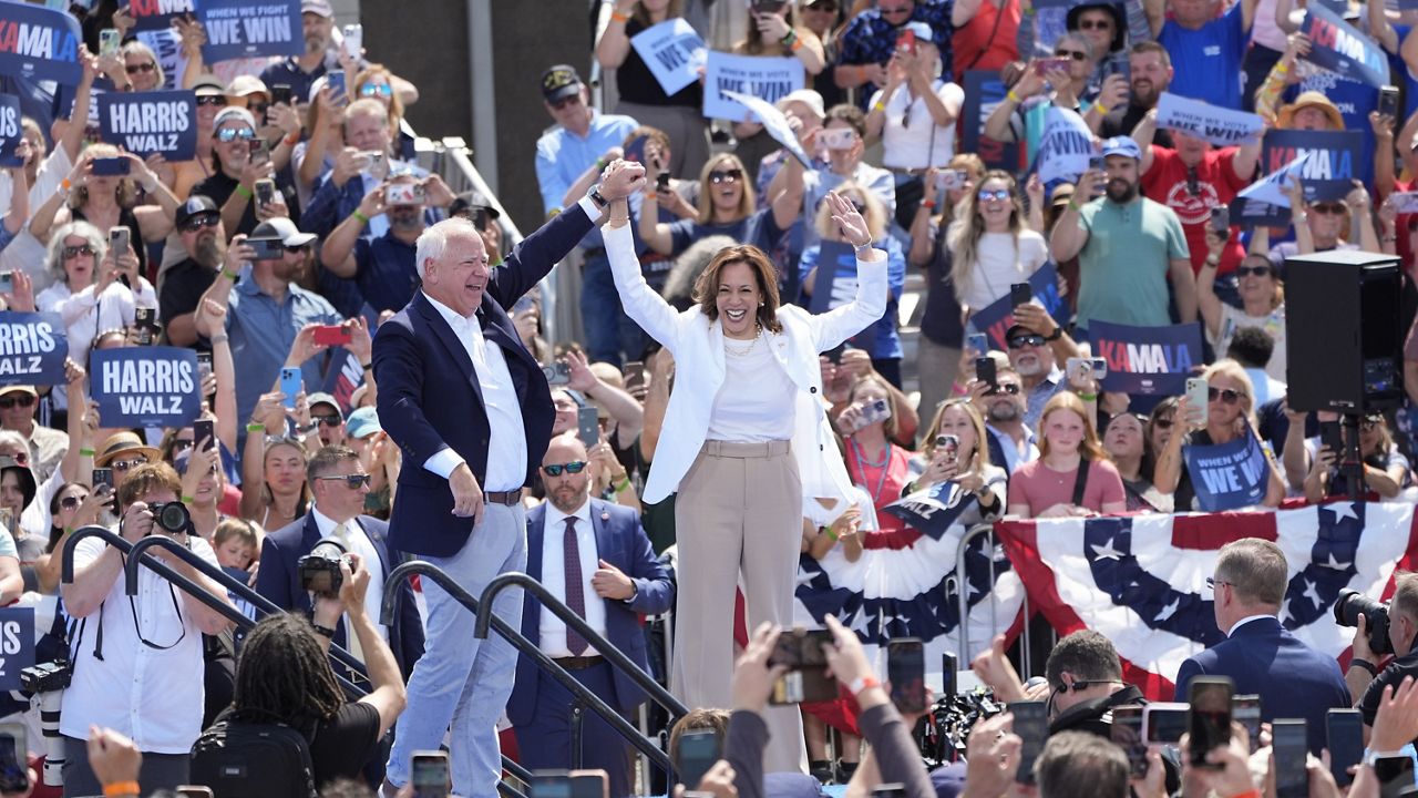 Democratic presidential nominee Vice President Kamala Harris is welcomed by Democratic vice presidential nominee Minnesota Gov. Tim Walz, before she delivers remarks at a campaign event, Wednesday, Aug. 7, 2024, in Eau Claire, Wisc. (AP Photo/Charles Rex Arbogast)