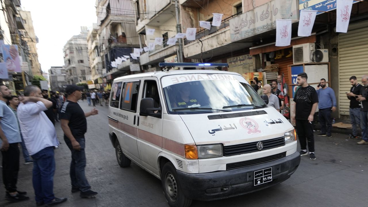 An ambulance believed to be carrying wounded people, after multiple explosions were heard during the funeral of four Hezbollah fighters who were killed Monday after their handheld pagers exploded, in the southern suburb of Beirut, Lebanon, Wednesday, Sept. 18, 2024. (AP Photo/Bilal Hussein)