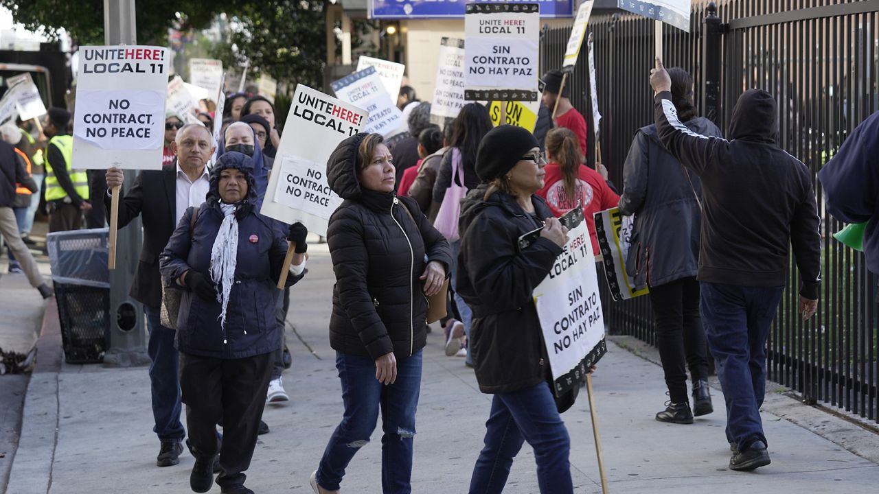 Unite Here Local 11 workers hold a rally as they protest outside the Figueroa Hotel in downtown Los Angeles on Friday, April 5, 2024. (AP Photo/Damian Dovarganes)