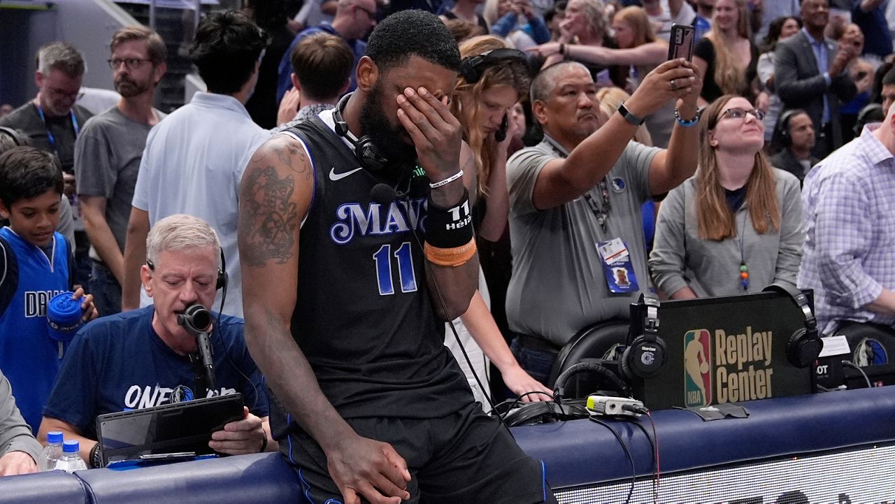 Dallas Mavericks' Kyrie Irving (11) pauses as he waits to do a broadcast interview following the teams win in Game 6 of an NBA basketball second-round playoff series against the Oklahoma City Thunder Saturday, May 18, 2024, in Dallas. (AP Photo/Tony Gutierrez)