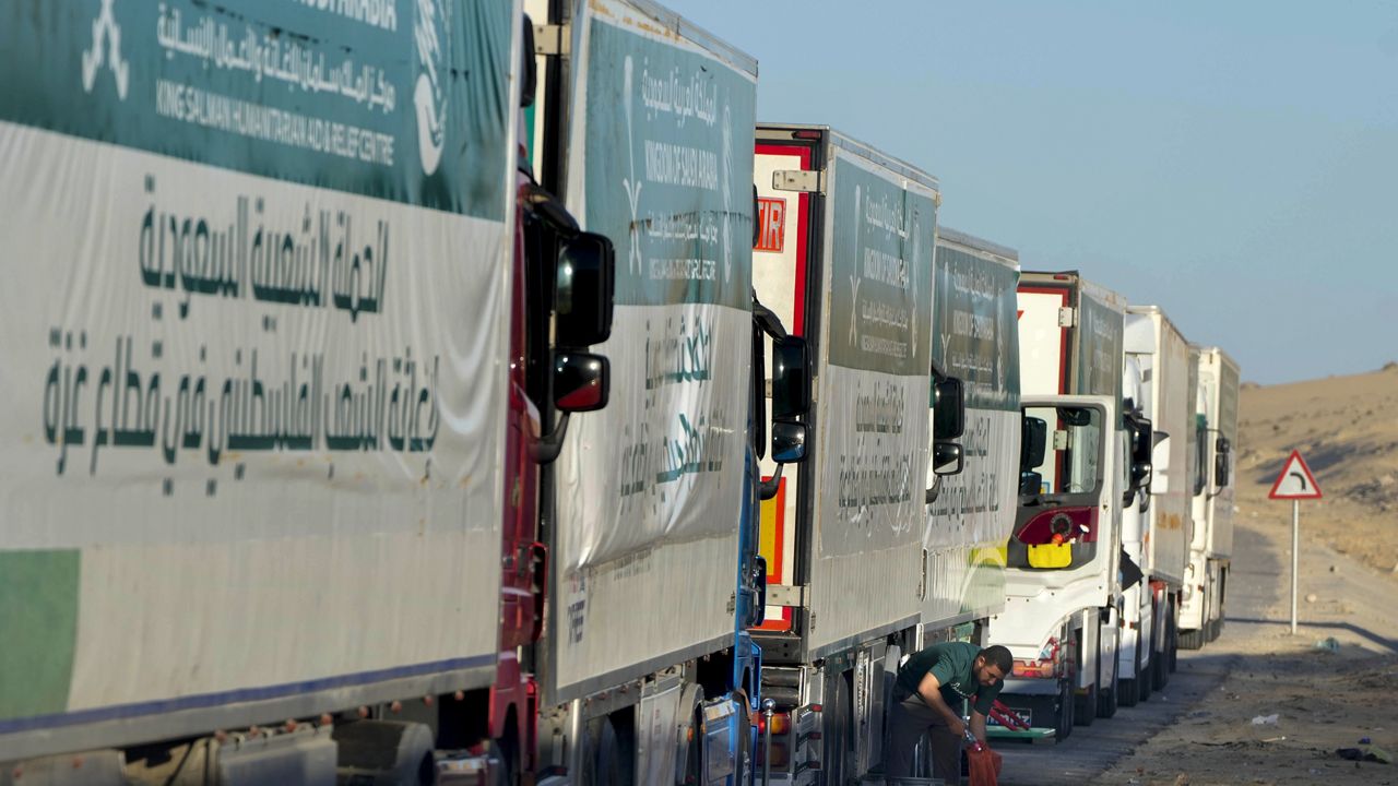 Trucks carrying humanitarian aid from King Salman humanitarian aid and relief center (KSrelief), line up as they prepare to cross Rafah crossing port to Gaza Strip, Wednesday, Nov. 29, 2023. (AP Photo/Amr Nabil)
