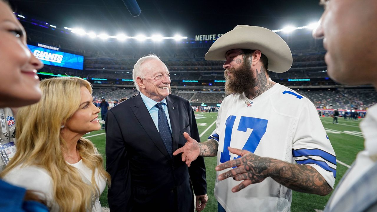 Music artist Post Malone, center, meets with Dallas Cowboys owner Jerry Jones before an NFL football game against the New York Giants, Thursday, Sept. 26, 2024, in East Rutherford, N.J. (AP Photo/Bryan Woolston)