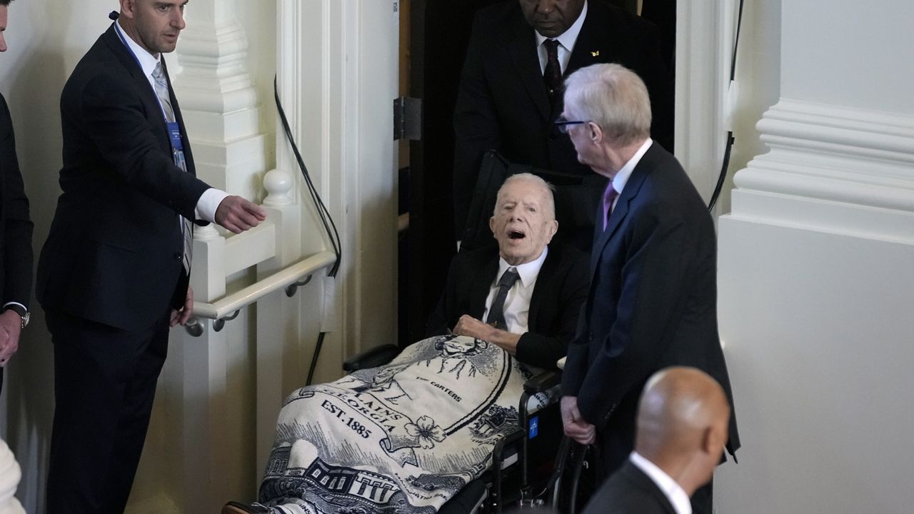 Former President Jimmy Carter, arrives to attend a tribute service for his wife and former first lady Rosalynn Carter, at Glenn Memorial Church, Tuesday, Nov. 28, 2023, in Atlanta. (AP Photo/Andrew Harnik)