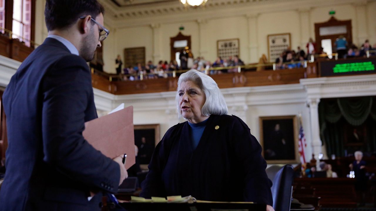 Texas Sen. Judith Zaffirini, D-Laredo, right, talks on the floor before a debate at the Texas Capitol, Tuesday, Feb. 7, 2017, in Austin, Texas. (AP Photo/Eric Gay)