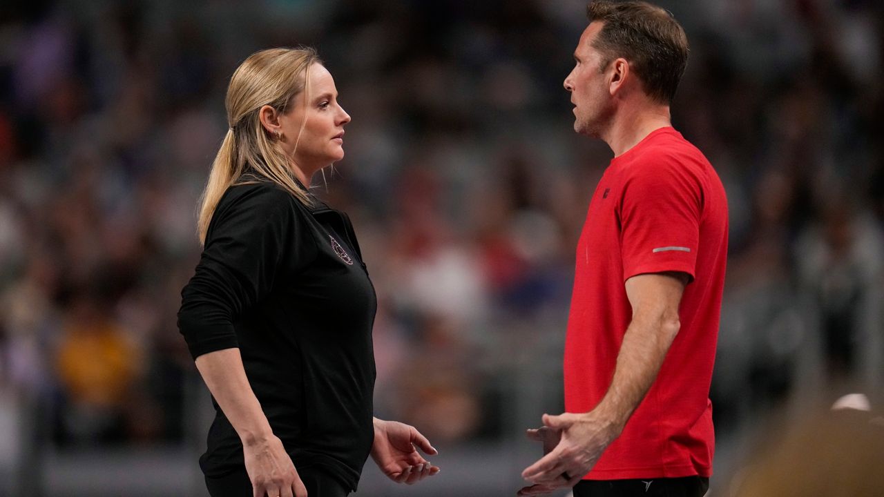 Cecile & Laurent Landi, coaches of Simone Biles, chat before she participates on the vault during the U.S. Gymnastics Championships, Sunday, June 2, 2024, in Fort Worth, Texas. (AP Photo/Julio Cortez, File)