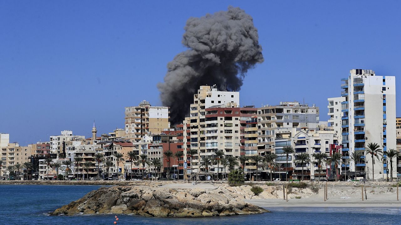 Smoke rises from buildings hit in an Israeli airstrike in Tyre, Lebanon, Wednesday, Oct. 23, 2024. (AP Photo/Mohammad Zaatari)