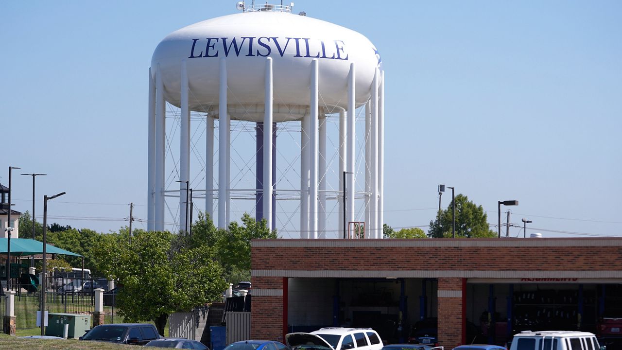 A water tower sits near businesses in Lewisville, Texas, Wednesday, Oct. 2, 2024. (AP Photo/LM Otero)