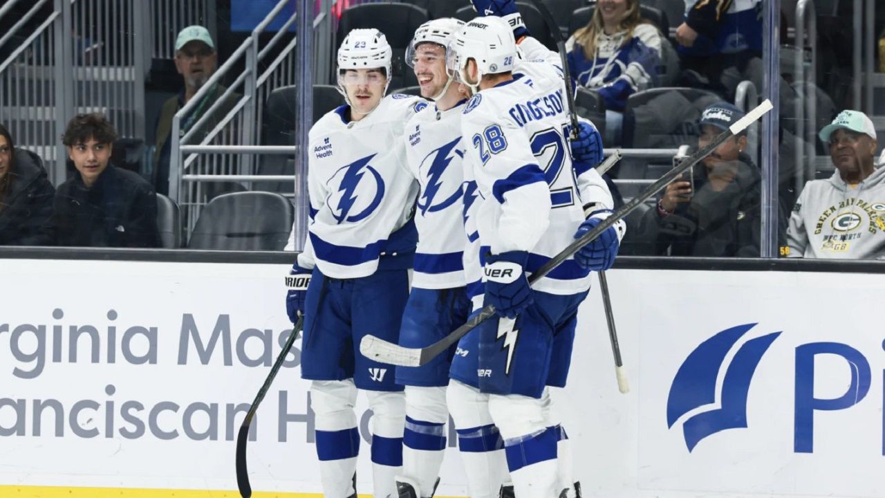 Tampa Bay Lightning defenseman Declan Carlile, center, celebrates with teammates Michael Eyssimont, left, and Zemgus Girgensons, right, after scoring a goal during the third period of an NHL hockey game against the Seattle Kraken Saturday, Dec. 14, 2024, in Seattle. (AP Photo/Maddy Grassy)