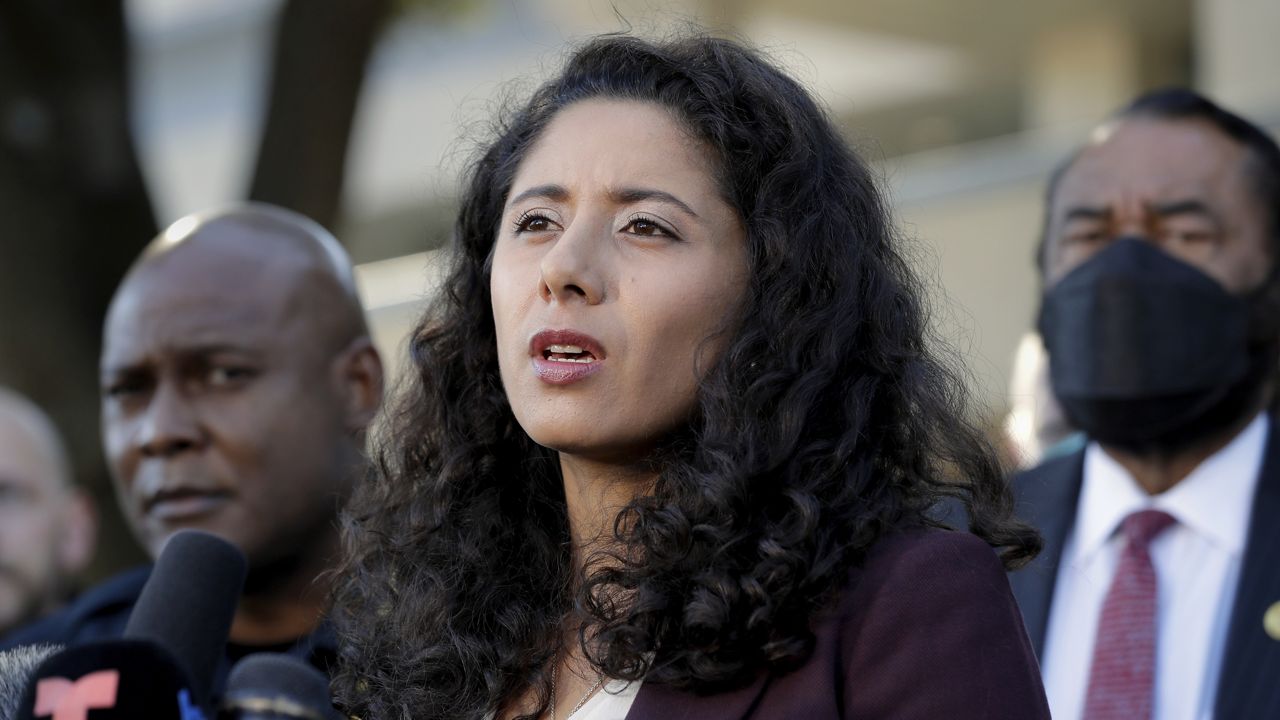 Harris County Judge Lina Hidalgo, center, flanked by Houston Police Chief Troy Finner, left, and U.S. Rep. Al Green, right, speaks during a news conference, Nov. 6, 2021, in Houston. (AP Photo/Michael Wyke)