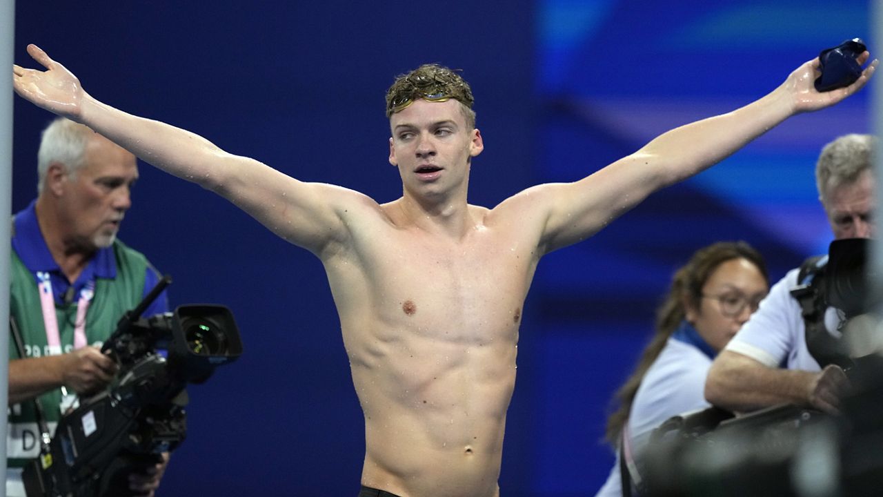 Leon Marchand of France, celebrates after winning the men's 200-meter individual medley final at the 2024 Summer Olympics, Friday, Aug. 2, 2024, in Nanterre, France. (AP Photo/Tsvangirayi Mukwazhi)