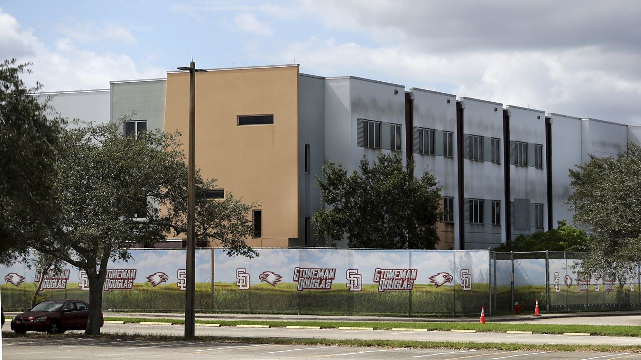 The 1200 building at Marjory Stoneman Douglas High School in Parkland, Fla., is seen, Oct. 20, 2021. Demolition of the building where 17 people died in the 2018 Parkland school shooting is set to begin, as crews will begin tearing down the three-story building at the high school on Thursday, June 13, 2024. (Carline Jean/South Florida Sun-Sentinel via AP)