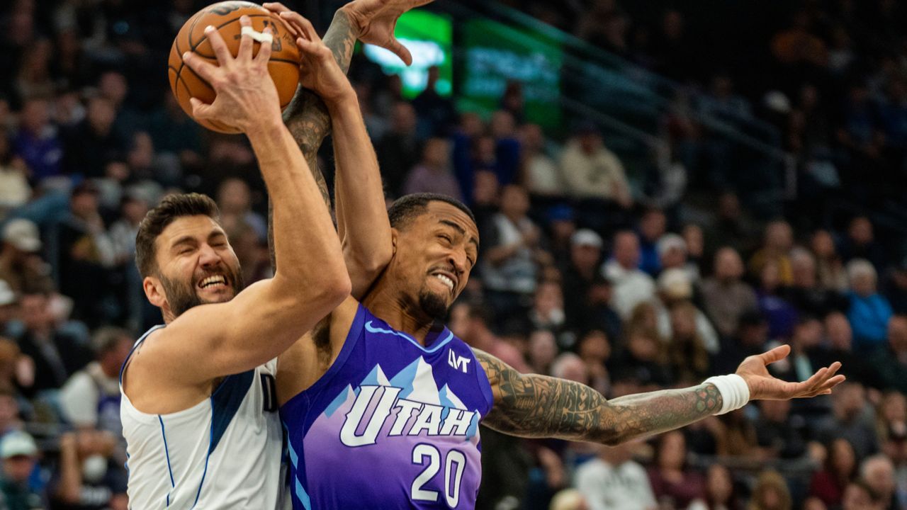 Dallas Mavericks forward Maxi Kleber, left, gets tangled up with Utah Jazz forward John Collins (20) during the first half of an NBA basketball game Thursday, Nov. 14, 2024, in Salt Lake City. (AP Photo/Rick Egan)