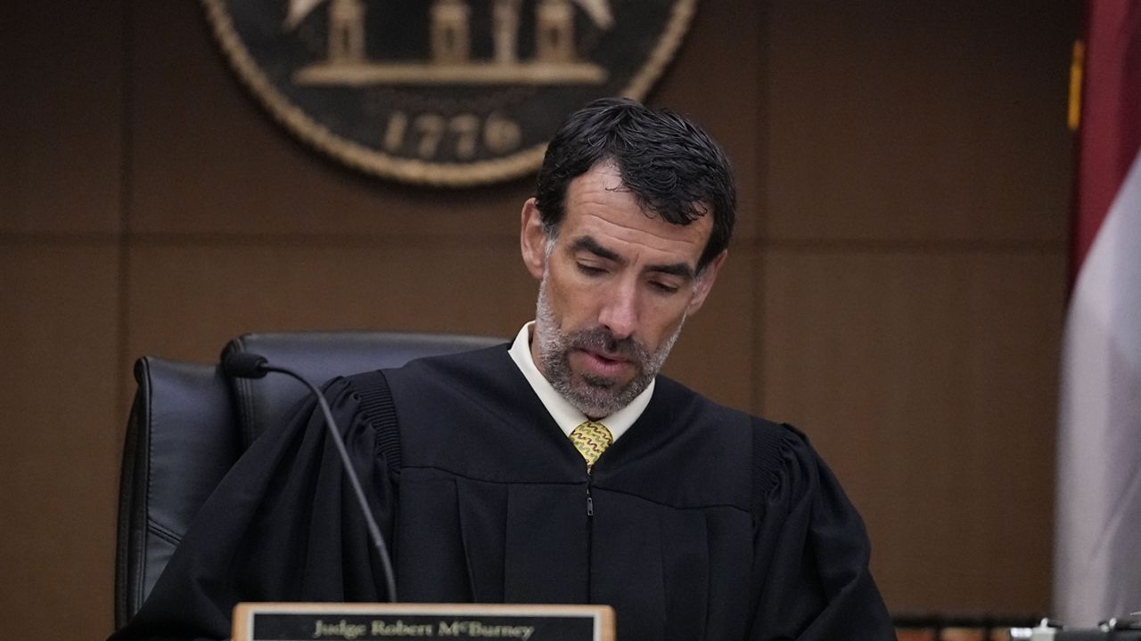 Fulton County Superior Court Judge Robert McBurney looks through paperwork, Monday, Aug. 14, 2023, in Atlanta. (AP Photo/Brynn Anderson)