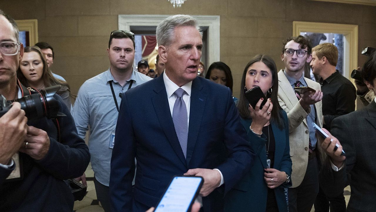 Former Speaker of the House Kevin McCarthy, R-Calif., talks to reporters as he walks to his office at the Capitol in Washington, Monday, Oct. 9, 2023. (AP Photo/Jose Luis Magana)