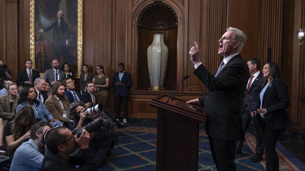 Speaker of the House Kevin McCarthy, R-Calif., pauses as he addresses reporters about efforts to pass appropriations bills and avert a looming government shutdown, at the Capitol in Washington, Friday, Sept. 29, 2023. He is joined at right by House Homeland Security Chair Mark Green, R-Tenn., and Rep. Monica de la Cruz, R-Texas. (AP Photo/J. Scott Applewhite)
