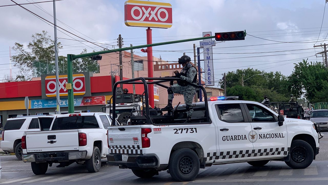 Mexican soldiers stand guard outside an Oxxo grocery shop near the Tamaulipas Chamber of Commerce, where its president Julio Cesar Almanza was killed, in Matamoros, Mexico, Tuesday, July 30, 2024. (AP Photo/Veronica Cisneros)