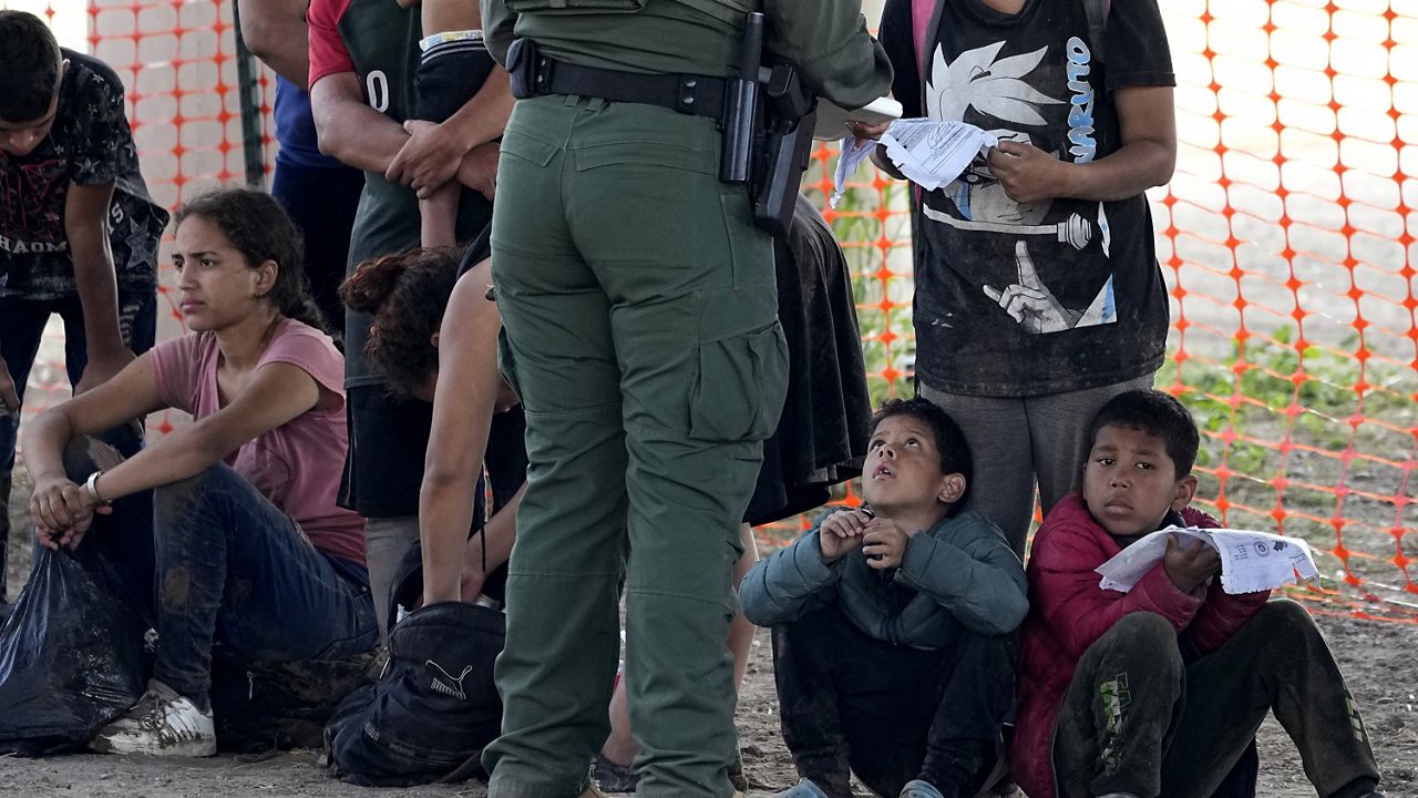 Migrants who crossed into the U.S. from Mexico wait to be processed by U.S. Border Patrol agents, Thursday, Sept. 21, 2023, in Eagle Pass, Texas. Migrants have always come to the U.S., but the immigration system now seems strained nationwide more than ever. (AP Photo/Eric Gay)