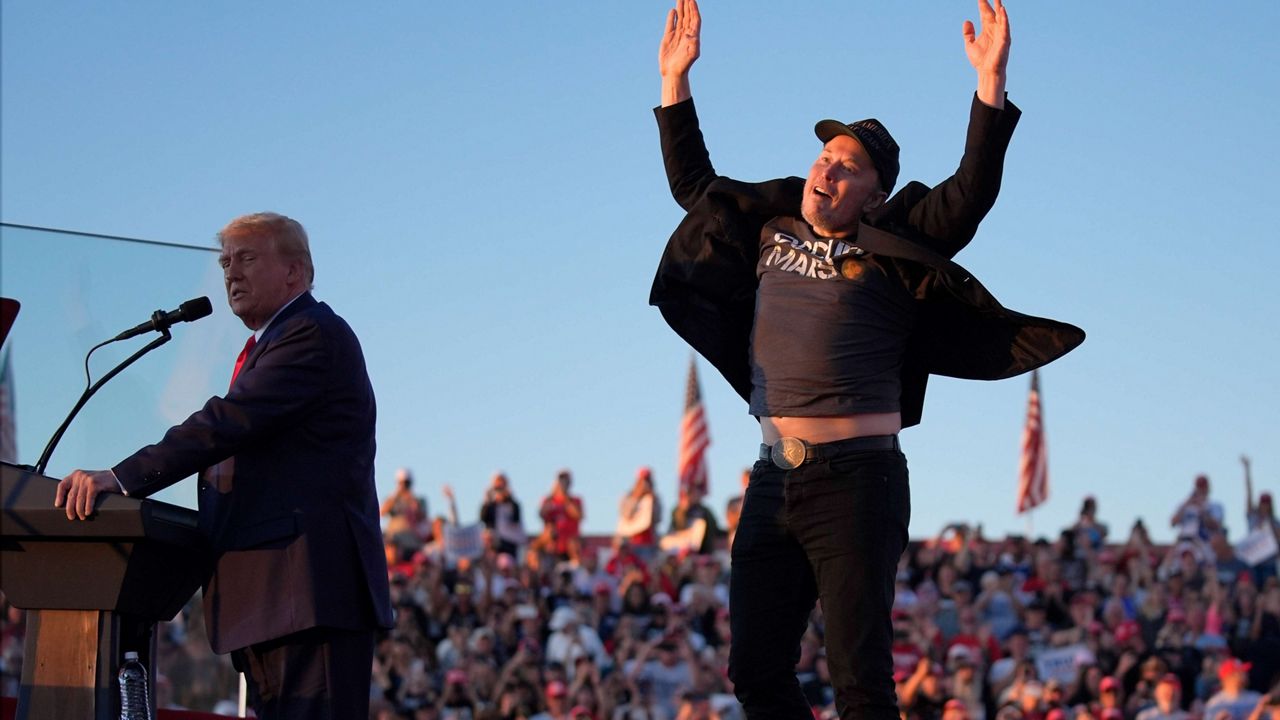 Elon Musk jumps on the stage as Republican presidential nominee former President Donald Trump speaks at a campaign rally at the Butler Farm Show, Saturday, Oct. 5, 2024, in Butler, Pa. (AP Photo/Evan Vucci)