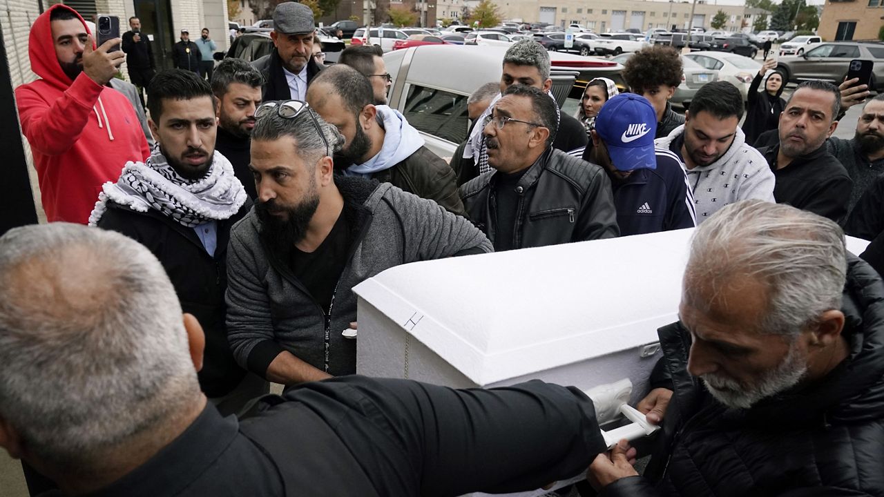 Family members of Wadea Al Fayoume bring his casket into Mosque Foundation in Bridgeview, Ill., Monday, Oct. 16, 2023. (AP Photo/Nam Y. Huh)