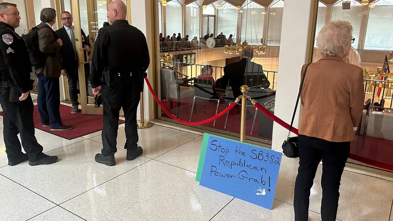 A placard expressing opposition to a Republican-penned measure being debated sits outside the North Carolina Senate gallery at a Legislative Building news conference in Raleigh, N.C., Wednesday, Nov. 20. 2024. (AP Photo/Gary D. Robertson)