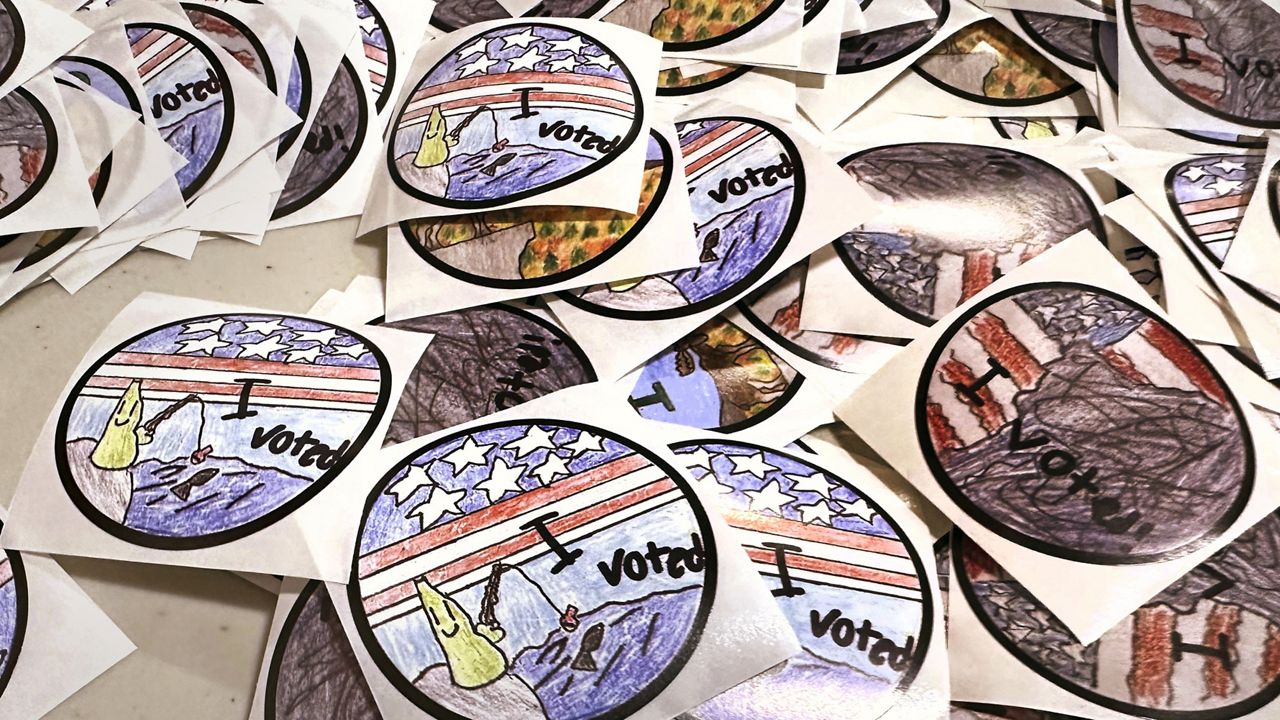 "I Voted" stickers, which were designed by New Hampshire fourth grade students, are displayed on a table at Pinkerton Academy , Tuesday, Jan. 23, 2024, in Derry, N.H., as New Hampshire's famously independent-minded electorate makes its pick for the 2024 presidential nominees. (AP Photo/Charles Krupa)