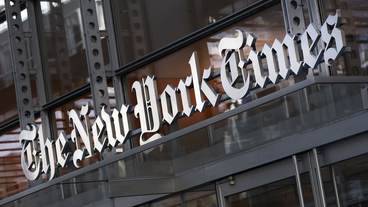 A sign for The New York Times hangs above the entrance to its building, Thursday, May 6, 2021 in New York. (AP Photo/Mark Lennihan)