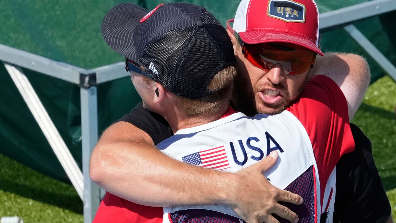 Vincent Hancock of the United States, right, hugs silver medalist and countryman Conner Lynn Prince after winning the gold medal in the Skeet men's final at the 2024 Summer Olympics, Saturday, Aug. 3, 2024, in Chateauroux, France. (AP Photo/Manish Swarup)