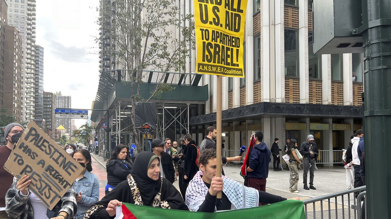 Pro-Palestinian protestors assemble on 42nd Street in New York City, Sunday, Oct. 8, 2023. The demonstration comes after the militant group Hamas attacked Israel on Saturday, Oct. 7. (AP Photo/Bobby Caina Calvan)