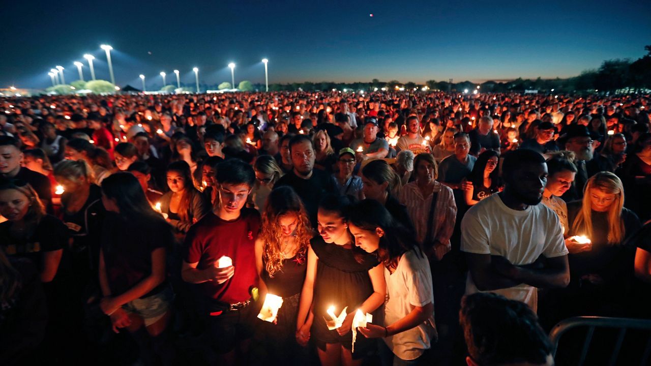 People attend a candlelight vigil for the victims of the shooting at Marjory Stoneman Douglas High School, in Parkland, Fla., Thursday, Feb. 15, 2018. (AP Photo/Gerald Herbert)