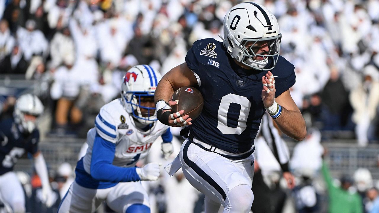 Penn State linebacker Dominic DeLuca returns an interception for a touchdown while being chased by SMU running back Brashard Smith during the first half in the first round of the NCAA College Football Playoff, Saturday, Dec. 21, 2024, in State College, Pa. (AP Photo/Barry Reeger)