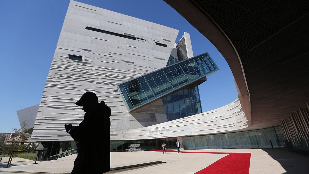 Visitors walk outside the front entrance of the of the Perot Museum of Nature and Science. (AP Photo/LM Otero)