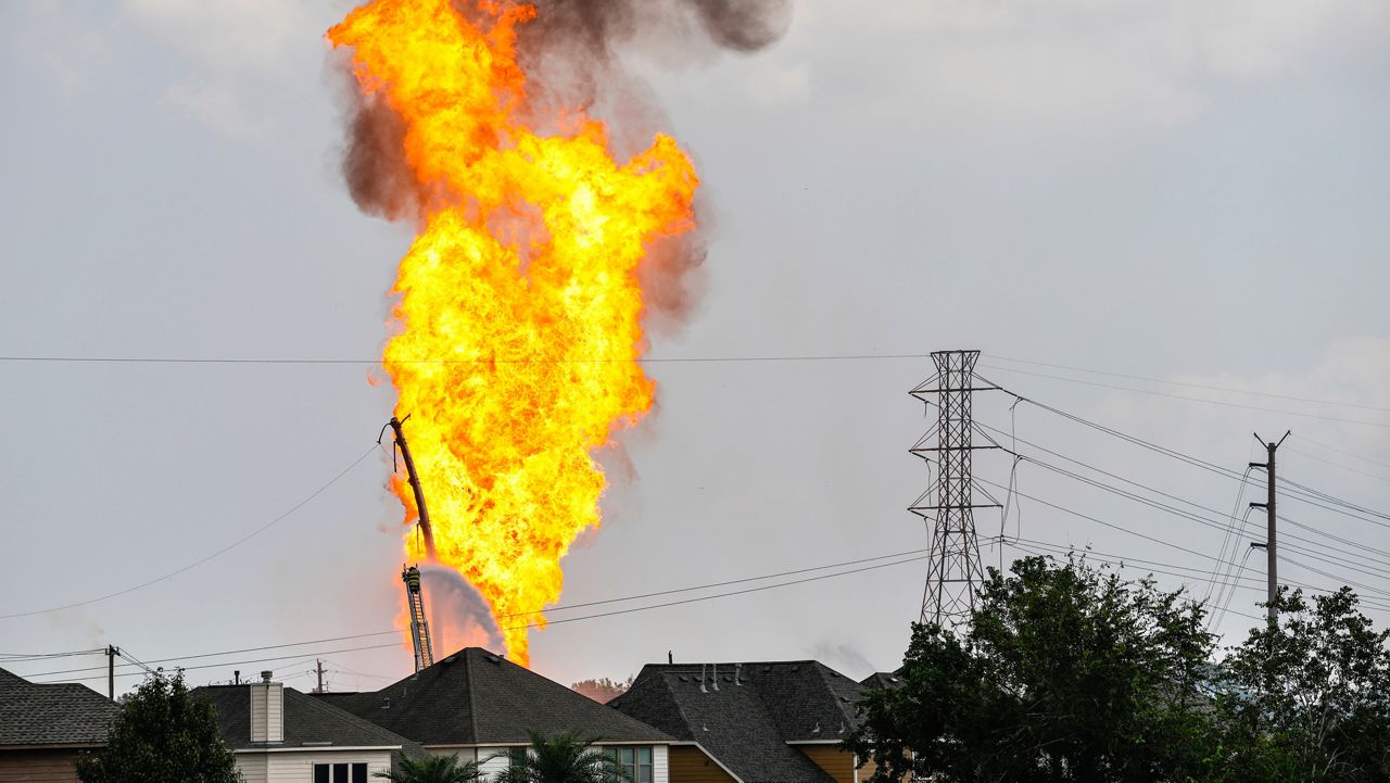 A firefighter directs a line of water around a fire on a pipeline carrying liquified natural gas near Spencer Highway and Summerton on Monday, Sept. 16, 2024, in La Porte, Texas. (Brett Coomer/Houston Chronicle via AP)