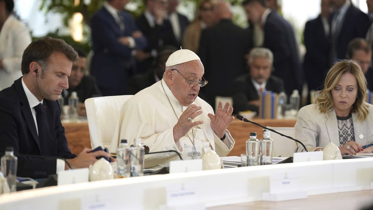 From left, French President Emmanuel Macron, left, and Italy's Prime Minister Giorgia Meloni, right, listen to Pope Francis speaking during a working session on Artificial Intelligence (AI), Energy, Africa-Mediterranean, on day two of the 50th G7 summit at Borgo Egnazia, southern Italy, on Friday, June 14, 2024. (Christopher Furlong/Pool Photo via AP)