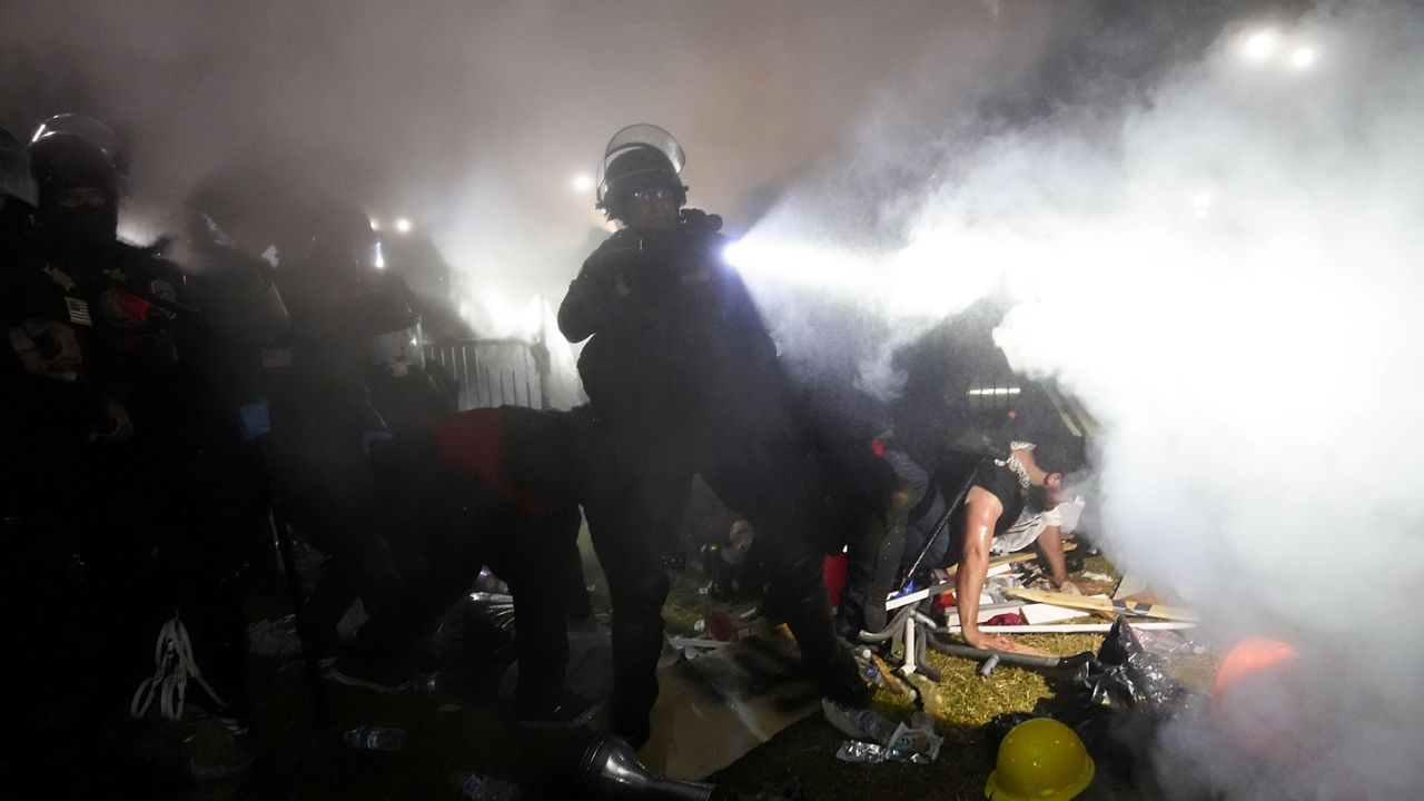 Police enter an encampment set up by pro-Palestinian demonstrators on the UCLA campus Thursday, May 2, 2024, in Los Angeles. (AP Photo/Jae C. Hong)