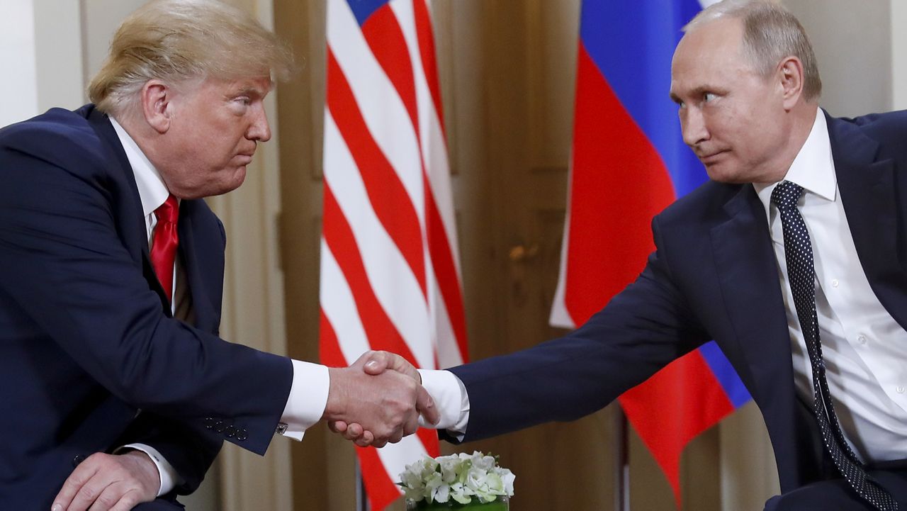 President Donald Trump, left, and Russian President Vladimir Putin shake hands at the beginning of a meeting at the Presidential Palace in Helsinki, Finland, July 16, 2018. (AP Photo/Pablo Martinez Monsivais)