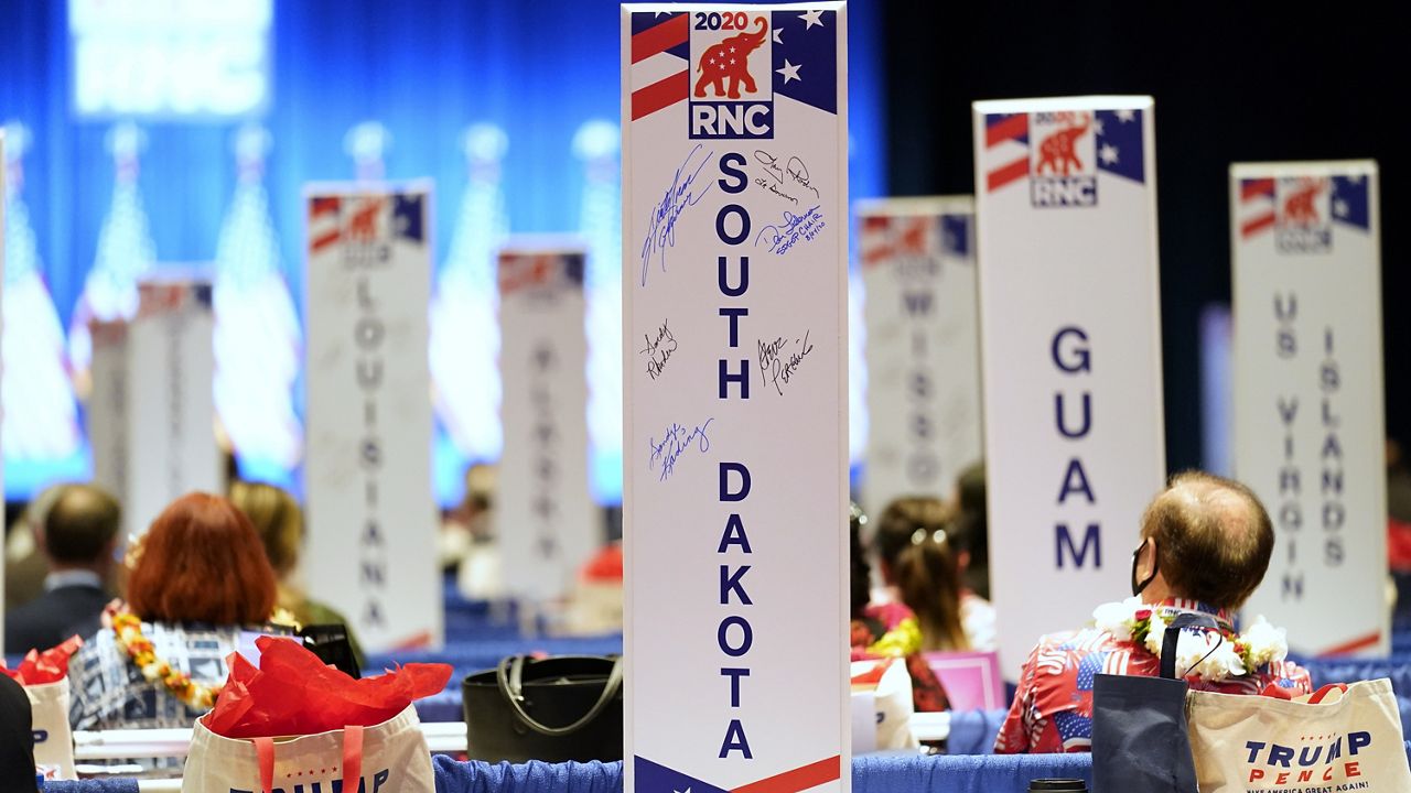 Delegates watch as the roll call vote of states continues after Vice President Mike Pence spoke at the 2020 Republican National Convention in Charlotte, N.C., Aug. 24, 2020. (AP Photo/Andrew Harnik)