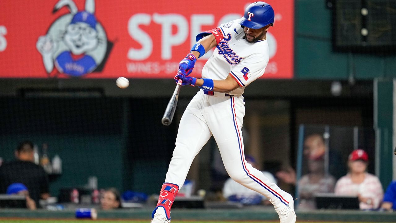 Texas Rangers' Leody Taveras hits a two-run home run off New York Mets pitcher Drew Smith during the seventh inning of a baseball game, Wednesday, June 19, 2024, in Arlington, Texas. Rangers' Corey Seager scored on the home run. (AP Photo/Julio Cortez)