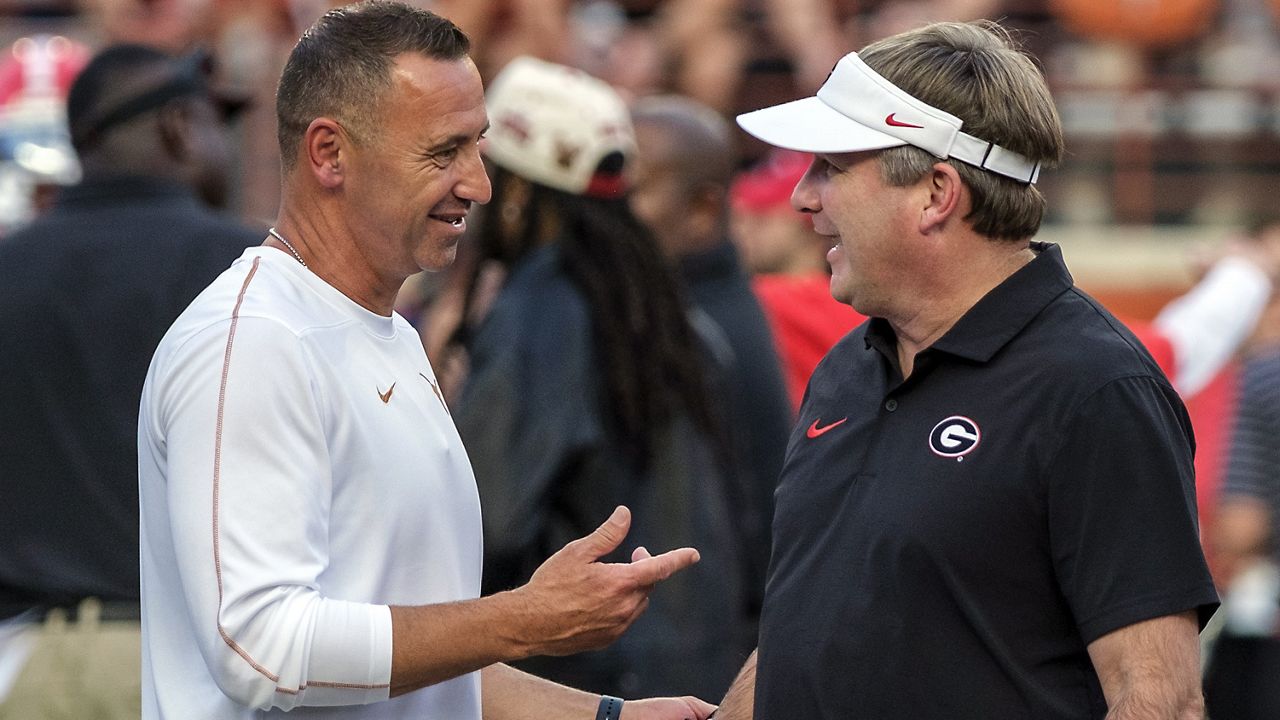 Texas head coach Steve Sarkisian, left, and Georgia head coach Kirby Smart talk during the pregame of an NCAA college football game in Austin, Texas, Saturday, Oct. 19, 2024. (AP Photo/Rodolfo Gonzalez)