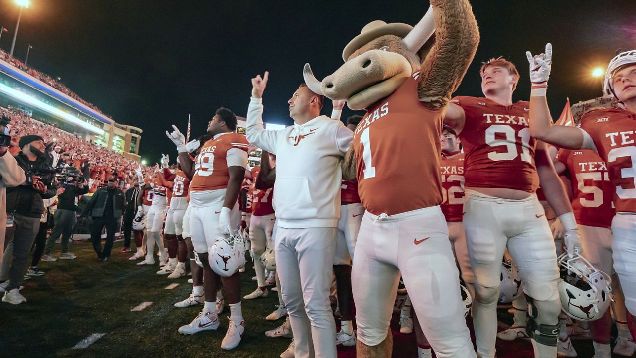 Texas coach Steve Sarkisian sings "The Eyes of Texas" with team the Bevo mascot after an NCAA college football game against Texas Tech, Friday, Nov. 24, 2023, in Austin, Texas. (AP Photo/Michael Thomas)