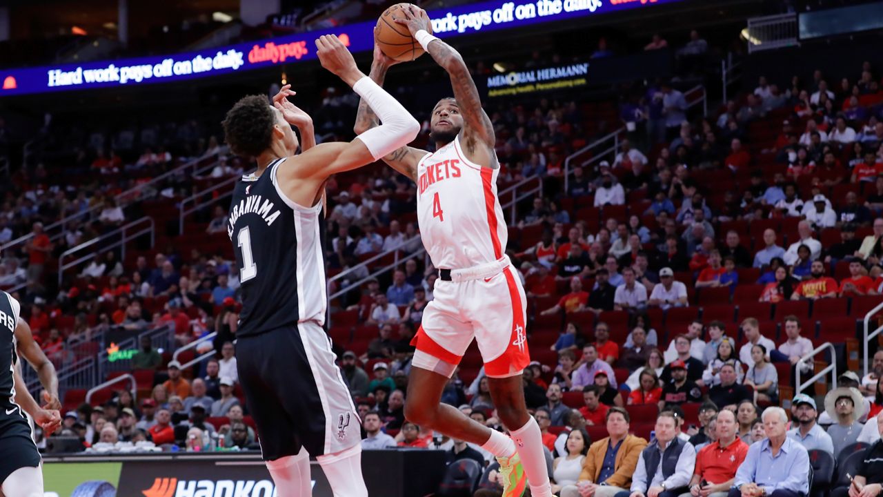 Houston Rockets guard Jalen Green (4) shoots over San Antonio Spurs center Victor Wembanyama (1) during the first half of an NBA basketball game Wednesday, Nov. 6, 2024, in Houston. (AP Photo/Michael Wyke)