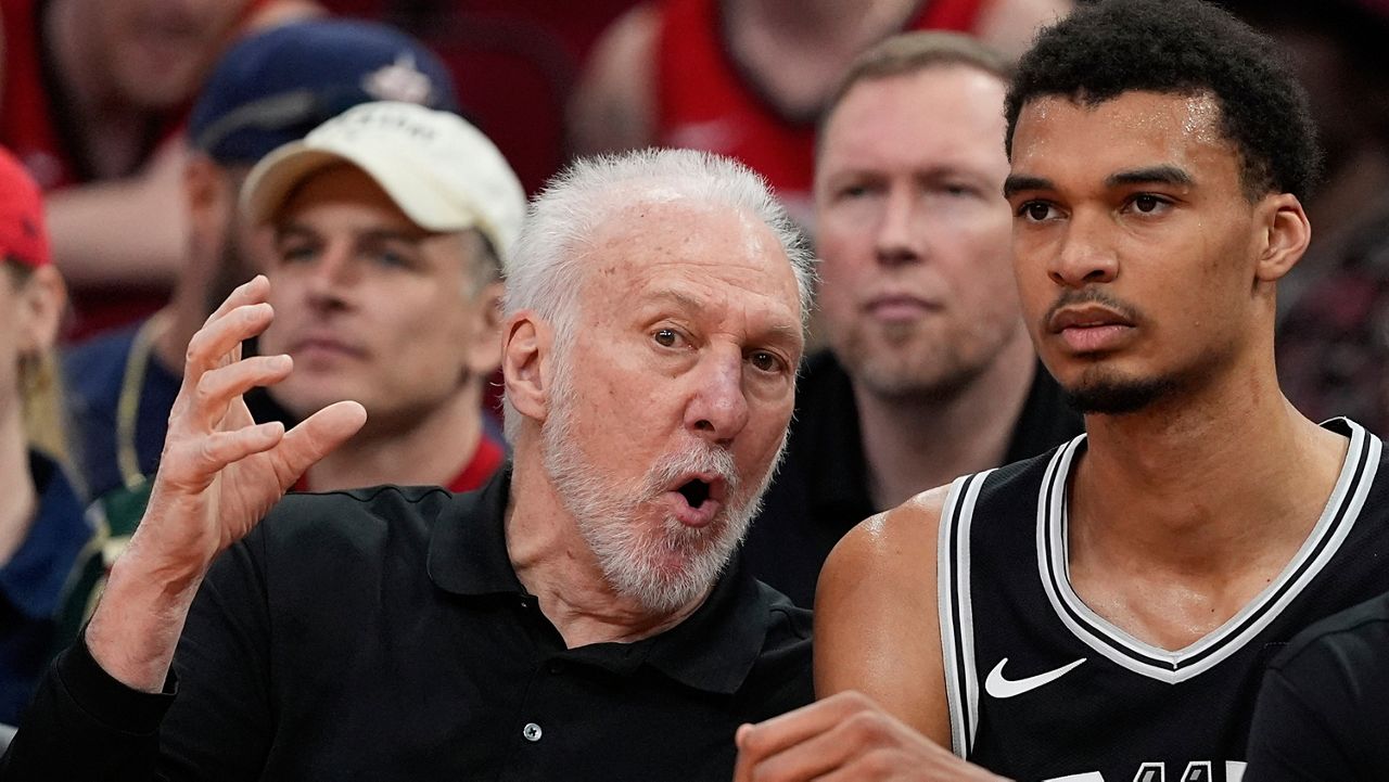 San Antonio Spurs coach Gregg Popovich, left, talks with Victor Wembanyama on the bench during the first half of an NBA basketball game against the Houston Rockets Tuesday, March 5, 2024, in Houston. (AP Photo/David J. Phillip)