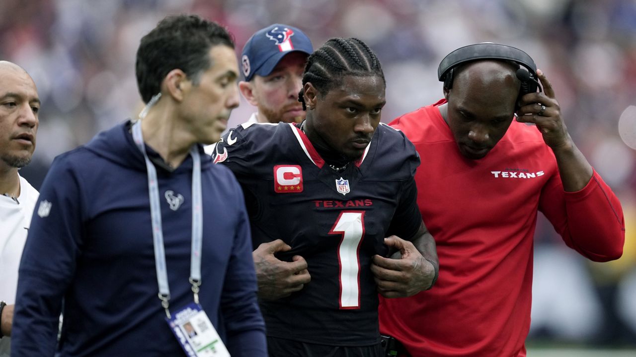 Houston Texans wide receiver Stefon Diggs (1) is helped off the field after getting injured during the second half of an NFL football game against the Indianapolis Colts, Sunday, Oct. 27, 2024, in Houston. (AP Photo/Eric Christian Smith)