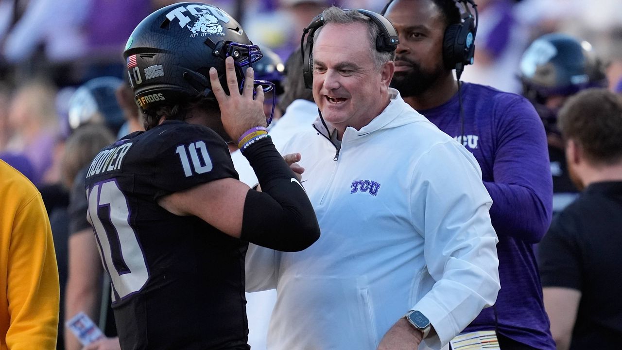 TCU head coach Sonny Dykes, right, talks to quarterback Josh Hoover (10) during the second half of an NCAA college football game against Arizona, Saturday, Nov. 23, 2024, in Fort Worth, Texas. (AP Photo/LM Otero)